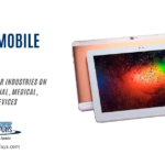 A blog post graphic titled "RUGGED MOBILE DEVICES" in large blue text. Below, smaller grey text reads "RUGGED DEVICES FOR INDUSTRIES ON THE MOVE. INDUSTRIAL, MEDICAL, TRANSPORTATION DEVICES". To the right, a slightly angled view of two rugged tablets is shown. The tablet in the foreground has a white bezel and displays a colorful, abstract image with dark background and bright speckles of red, green, blue, and yellow. The tablet behind it has a gold or tan back and is partially visible. The "AGDisplays" logo and website address are in the bottom left corner.