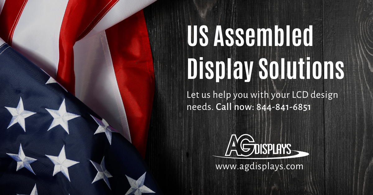 A promotional banner for US Assembled Display Solutions by AGDisplays. The left side features a portion of the American flag with visible stars and stripes, slightly blurred for depth of field. The right side has dark, wood-grain textured background with white text that reads "US Assembled Display Solutions" in a large font. Below that, smaller text says, "Let us help you with your LCD design needs. Call now: 844-841-6851." The AGDisplays logo and website address, www.agdisplays.com, are at the bottom right.