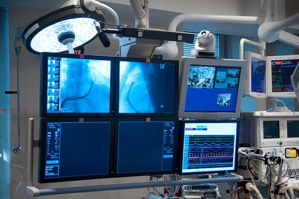 A group of LCD displays inside a hospital setting