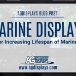 A slightly blurred image of a marine vessel's bridge or control room, featuring multiple electronic displays showing navigational data and radar screens, is overlaid with a light gray banner stating "AGDISPLAYS BLOG POST" at the top, followed by "MARINE DISPLAYS Tips for Increasing Lifespan of Marine LCDs," and the AGDisplays logo with "www.agdisplays.com" at the bottom. The overall scene suggests a technologically advanced maritime environment.