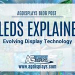 A background composed of overlapping and slightly transparent images related to digital technology and screens, overlaid with a white banner stating "AGDISPLAYS BLOG POST" at the top, followed by "OLEDS EXPLAINED Evolving Display Technology," and the AGDisplays logo with "www.agdisplays.com" at the bottom. The color palette is vibrant with blues, greens, and hints of red.