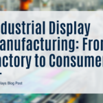 A slightly blurred image of an industrial manufacturing facility with robotic arms and workers assembling display screens, overlaid with a white banner stating "Industrial Display Manufacturing: From Factory to Consumer."