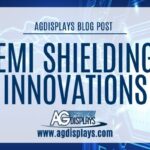 AGDisplays blog post banner featuring the title "EMI Shielding Innovations" in bold blue text on a futuristic blue circuit board background, with the AGDisplays logo and website URL below.