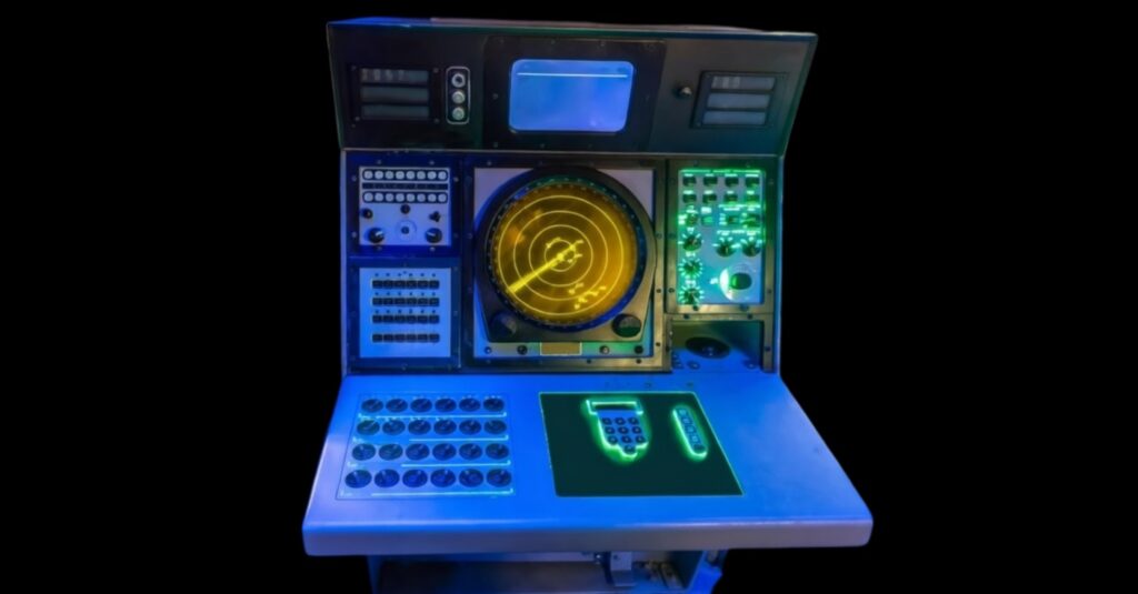 Rugged tactical display console with illuminated controls and circular radar screen, engineered for high-vibration and harsh environment applications in military and defense platforms.